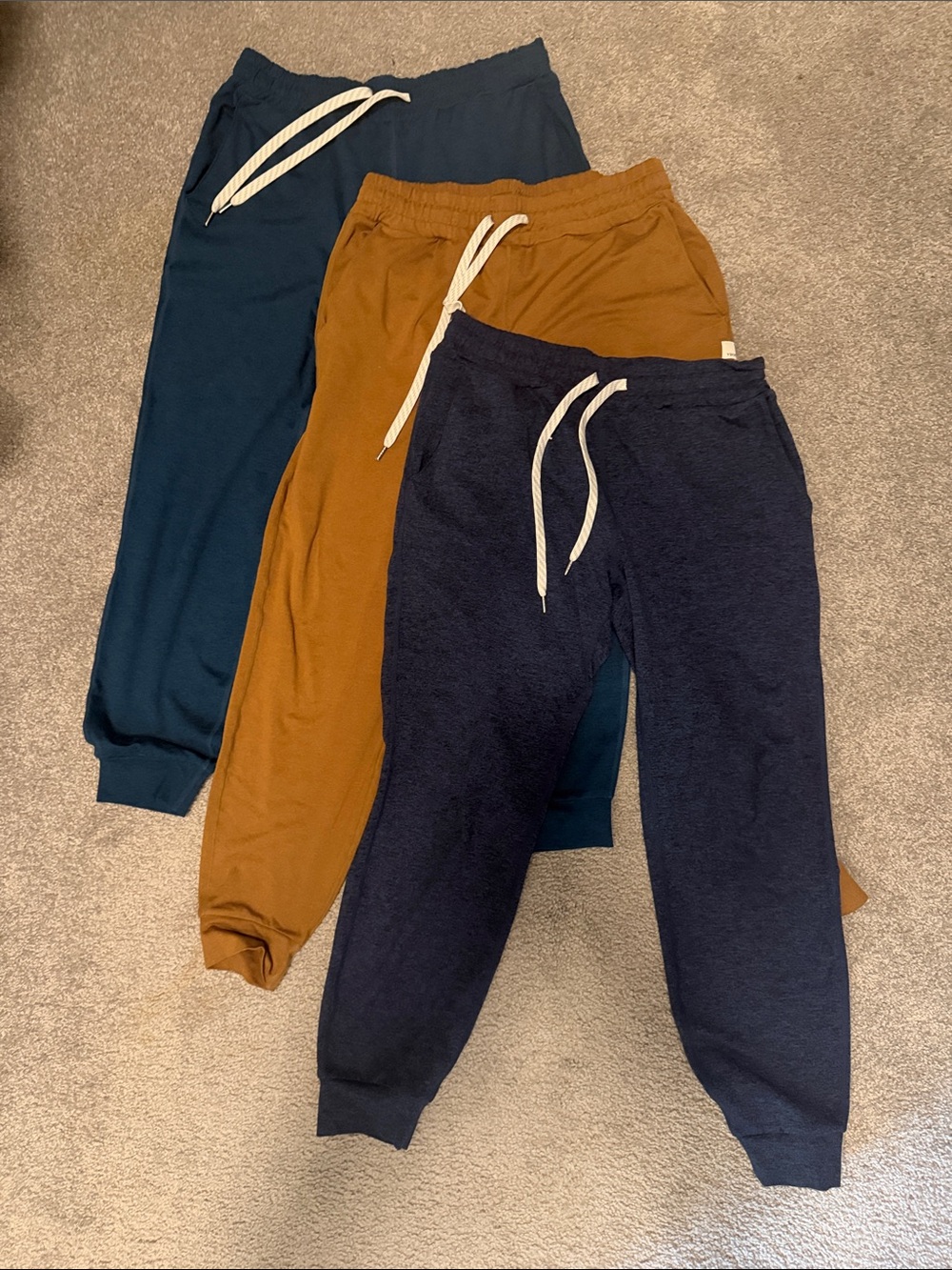 3 pairs of Womenโs Vuori Performance Jogger Pants - Navy,Golden Brown, Teal